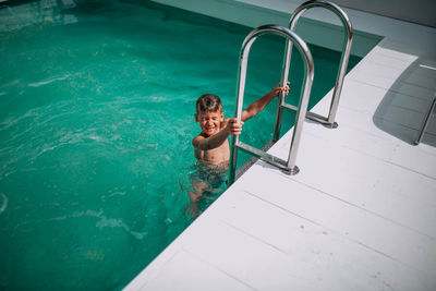 High angle view of shirtless man in swimming pool