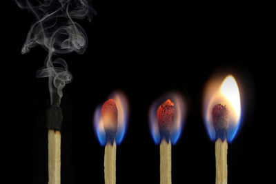 Close-up of matchsticks against black background