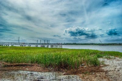 Scenic view of sea against cloudy sky