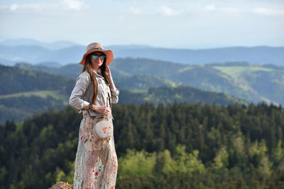 Woman standing against mountain