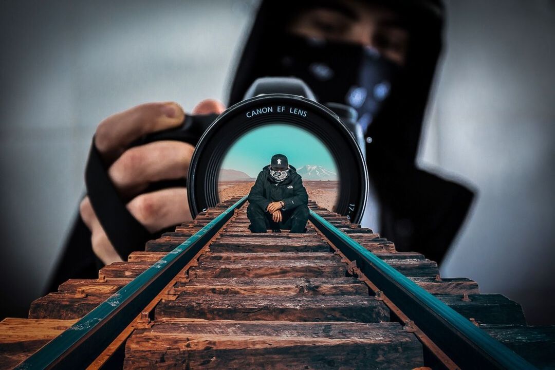 REFLECTION OF MAN PHOTOGRAPHING ON MIRROR