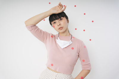 Portrait of a young woman against white background