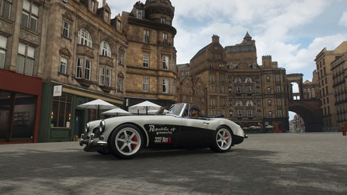 Cars on street against buildings in city