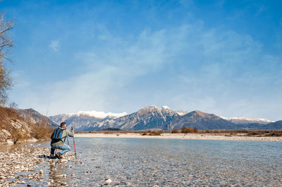 Man standing on mountain against sky