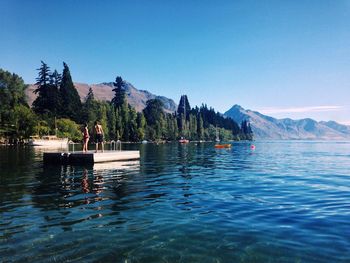 Scenic view of lake against clear blue sky