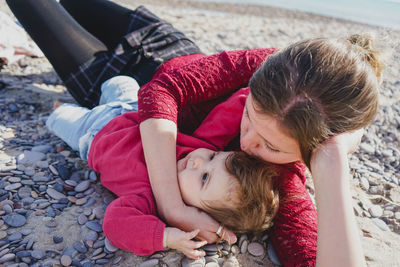 High angle view of mother and daughter at beach