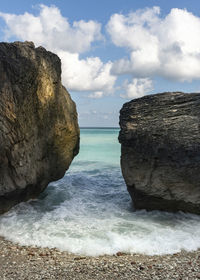 Rocks on sea shore against sky