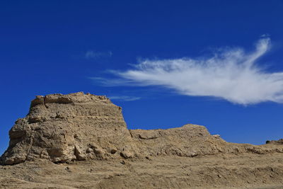 Low angle view of rock formations against sky