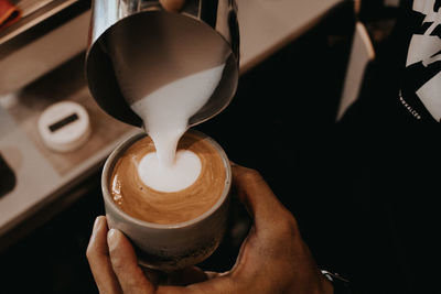 Close-up of hand holding coffee cup