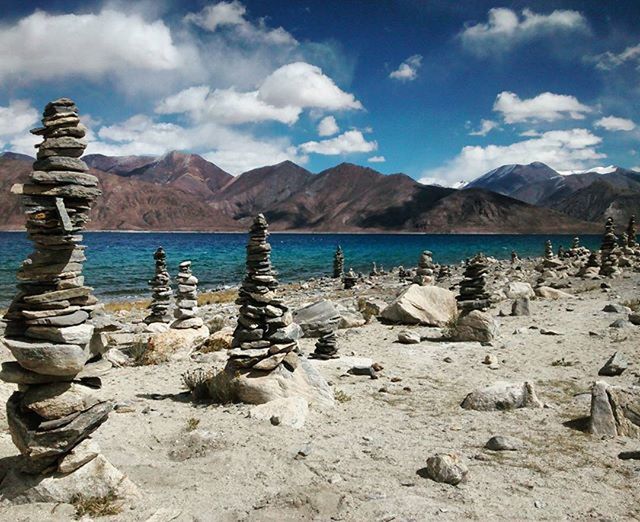 mountain, sky, mountain range, tranquil scene, tranquility, water, scenics, cloud - sky, beauty in nature, nature, cloud, lake, bird, rock - object, day, beach, cloudy, idyllic, landscape, non-urban scene