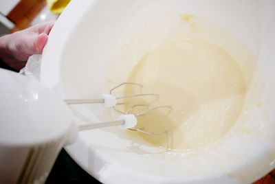 High angle view of person preparing batter in bowl