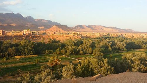 Scenic view of field and mountains against sky