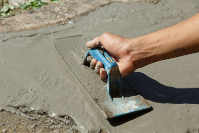 High angle view of person working on sand