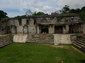 Abandoned building against cloudy sky