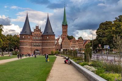 Panoramic view of temple and buildings against sky in city