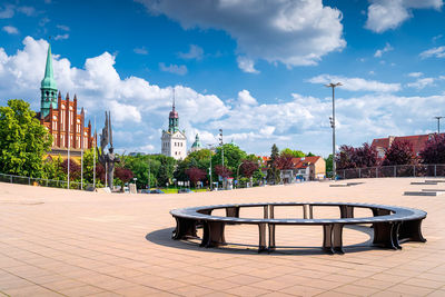 Gazebo in park by buildings against sky in city