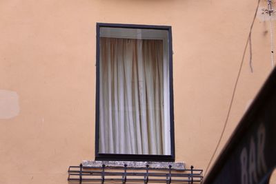 Low angle view of window on wall of building