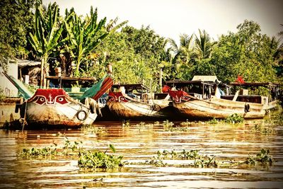 Boats moored in river