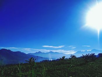 Scenic view of mountains against blue sky