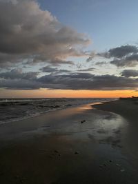 Scenic view of beach against sky during sunset