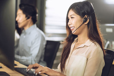 Midsection of woman working with mobile phone