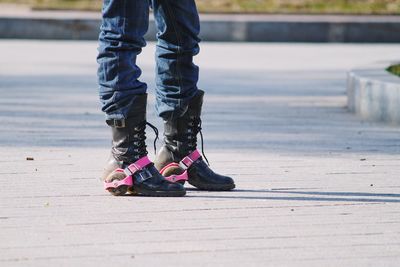 Low section of person wearing roller skates
