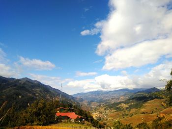 Scenic view of mountains against cloudy sky