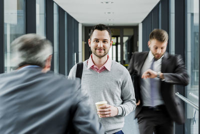 Calm businessman in contrast to businessmen in a hustle