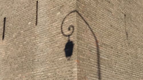 Low angle view of shadow on wall