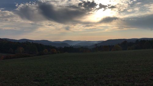 Scenic view of field against sky during sunset