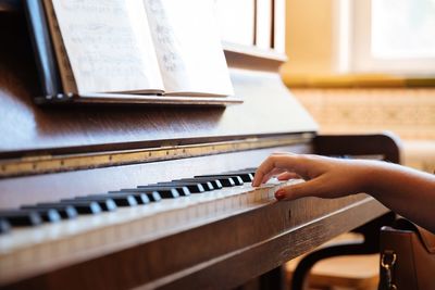 Midsection of woman playing piano