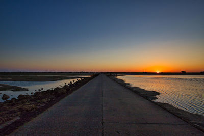 Scenic view of sea against clear sky during sunset