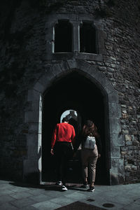 Rear view of people standing outside building