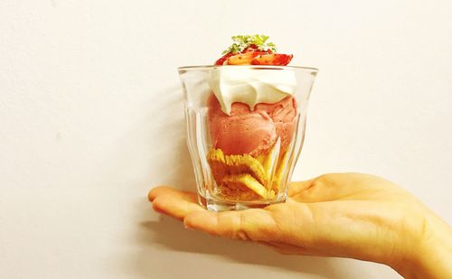 Close-up of hand holding ice cream