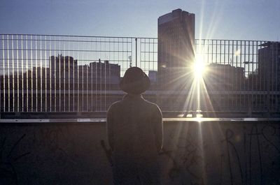 Sun shining through city skyline