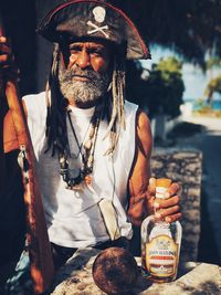 Full length of man holding ice cream standing outdoors