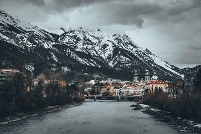 Snow covered houses and buildings against sky
