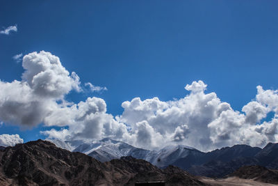 Low angle view of mountains against blue sky