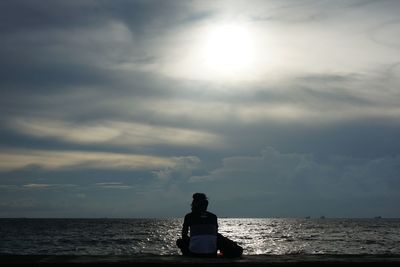 Rear view of man looking at sea