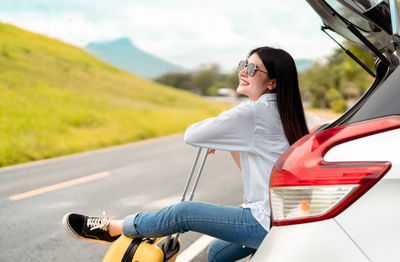 Woman sitting on a road