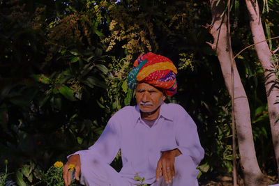 Portrait of woman standing against plants