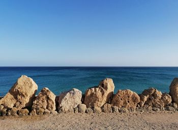 Scenic view of sea against clear blue sky