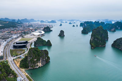 High angle view of sea by city against sky