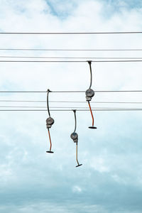 Low angle view of cable cars against sky