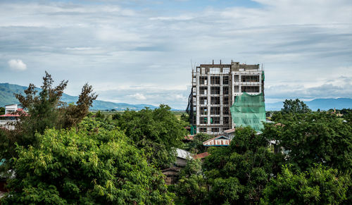 View of modern building against cloudy sky