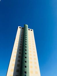 Low angle view of modern building against blue sky