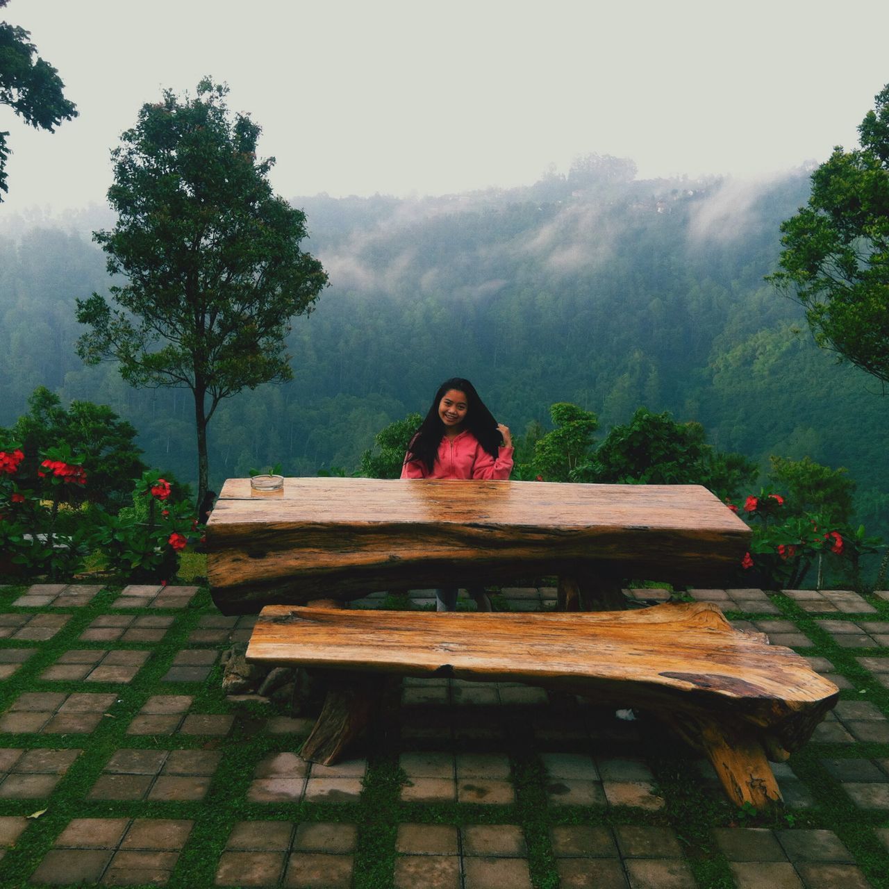 tree, sitting, lifestyles, tranquility, leisure activity, growth, nature, bench, plant, relaxation, tranquil scene, day, wood - material, casual clothing, built structure, rear view, beauty in nature, full length