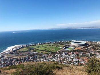 High angle view of townscape by sea against sky