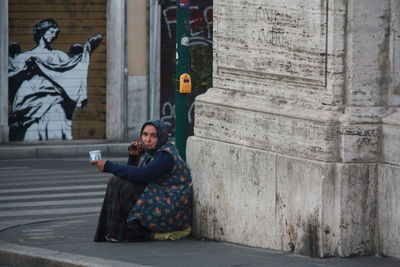 Portrait of woman sitting outdoors