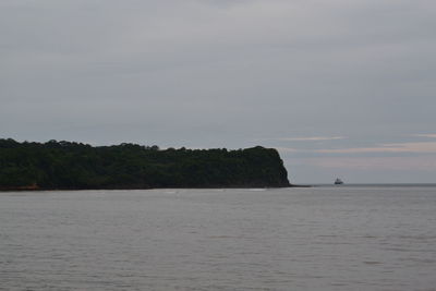 Scenic view of sea against cloudy sky